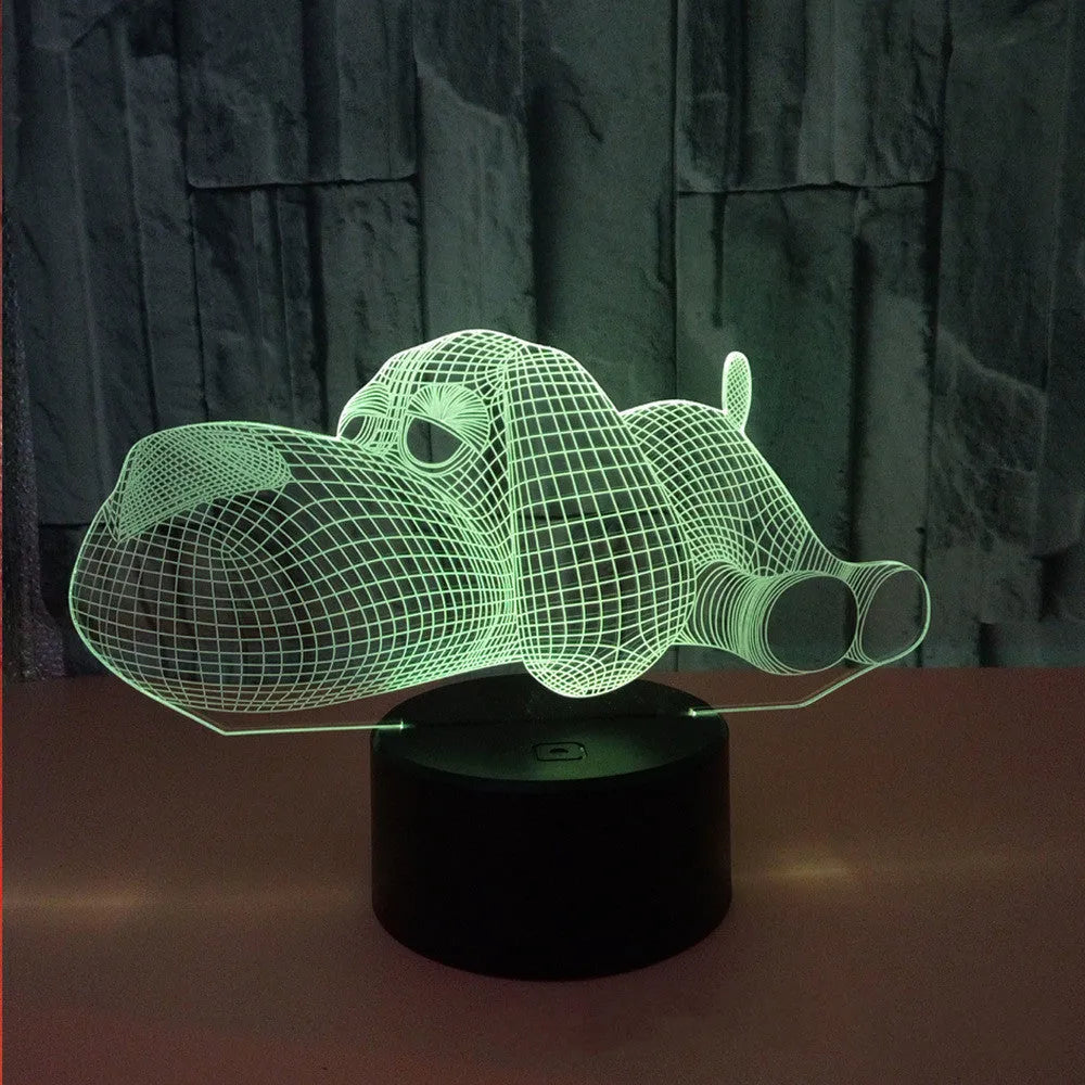 3D illusion dog lamp glowing in multiple colours on a desk with USB cable