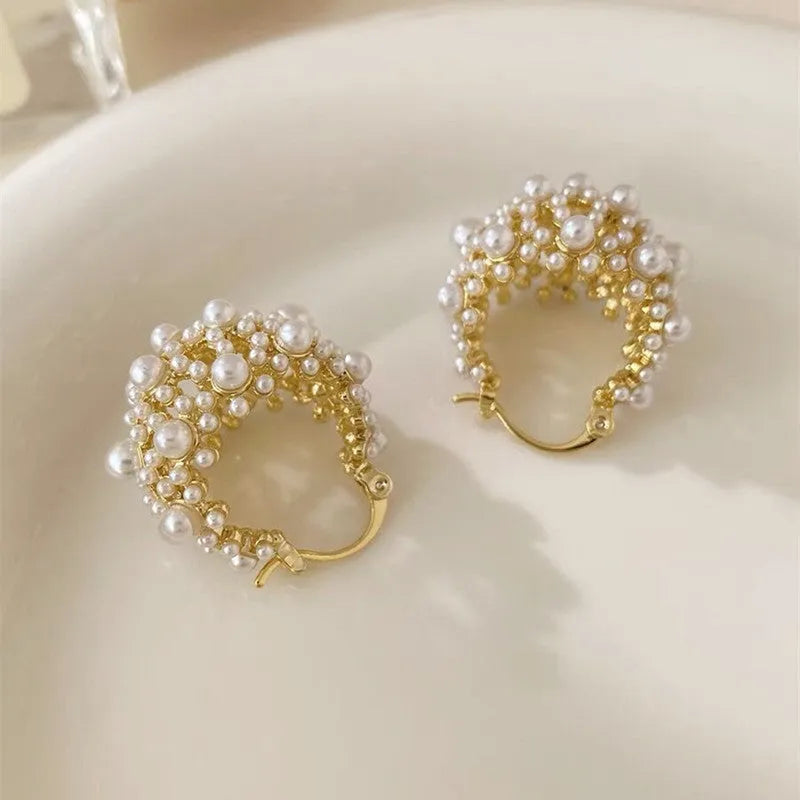 Gold-coloured copper flower basket earrings with small rice-shaped beads and pearl inlay detailing