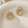 Gold-coloured copper flower basket earrings with small rice-shaped beads and pearl inlay detailing