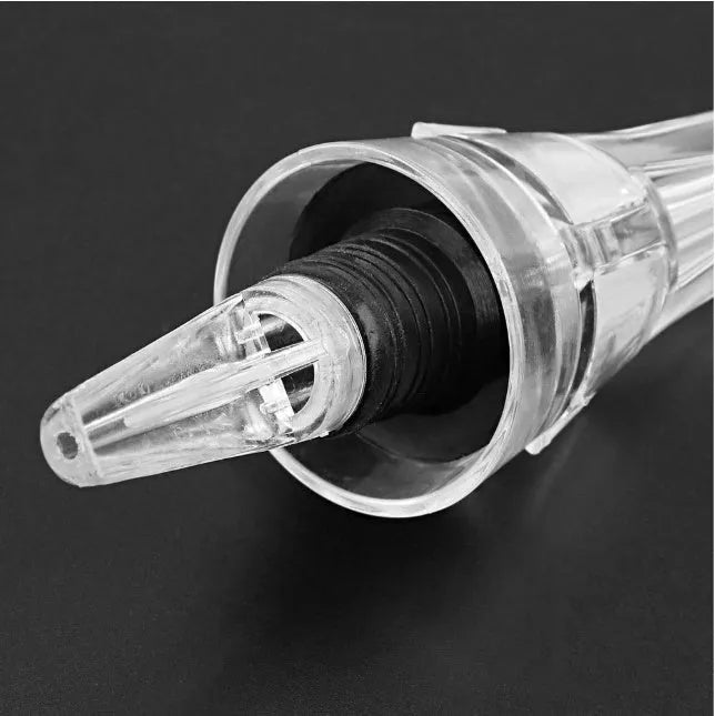 Clear acrylic wine aerator with stainless steel filter measuring 16x4.2cm pouring red wine into a glass
