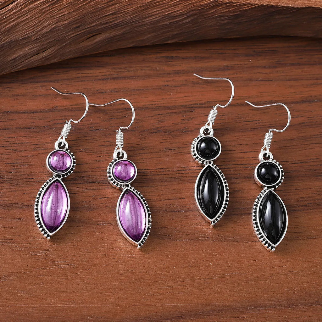Pair of vintage geometric pendant earrings in black and purple zinc alloy with round retro design