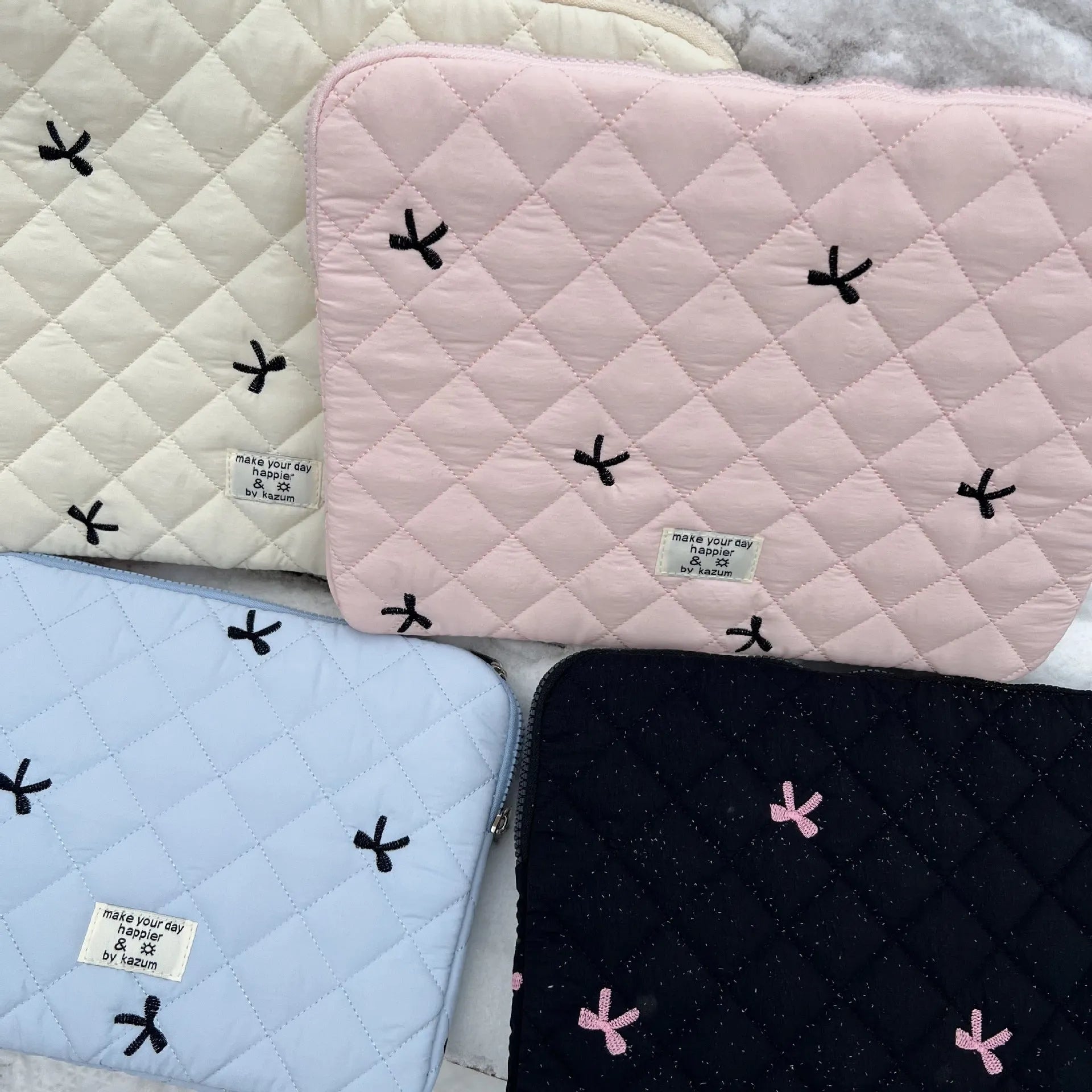 Cute rhombus embroidered bow laptop storage bag in nylon, shown in light pink colour.