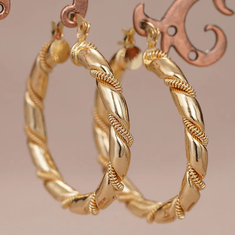 Geometric copper earrings with ring and line design elements in golden finish