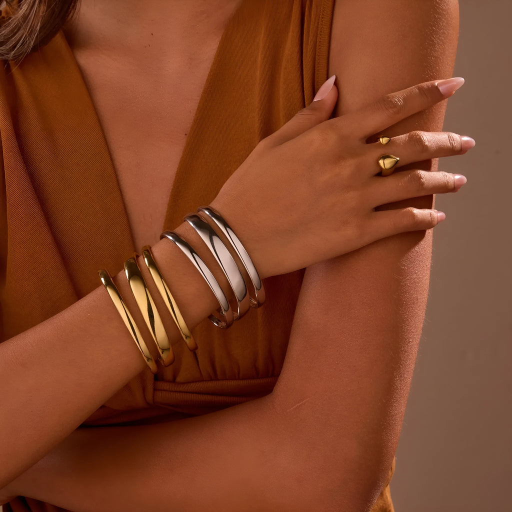Geometric line stainless steel bracelet for women, showing gold electroplated and natural steel finish options