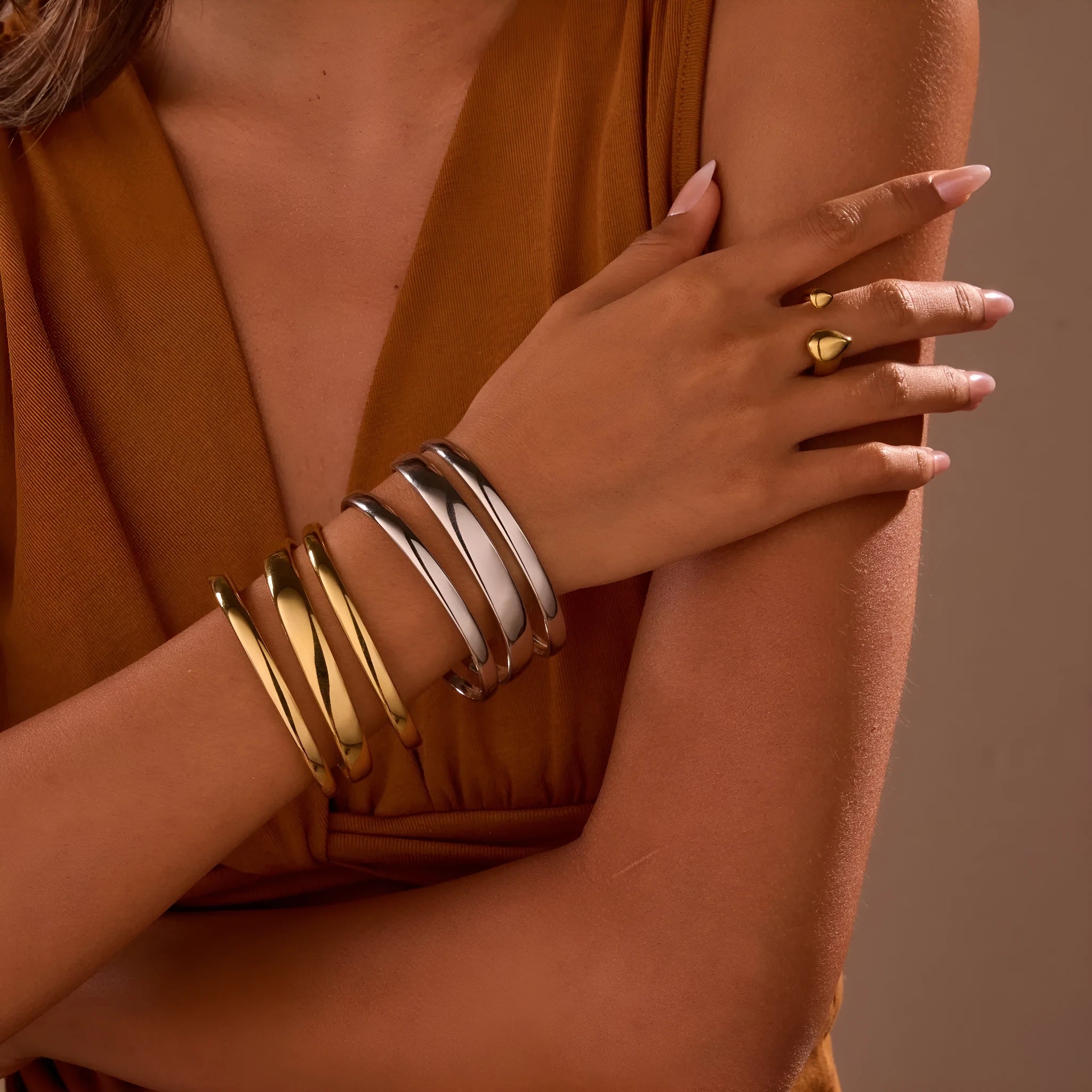 Geometric line stainless steel bracelet for women, showing gold electroplated and natural steel finish options