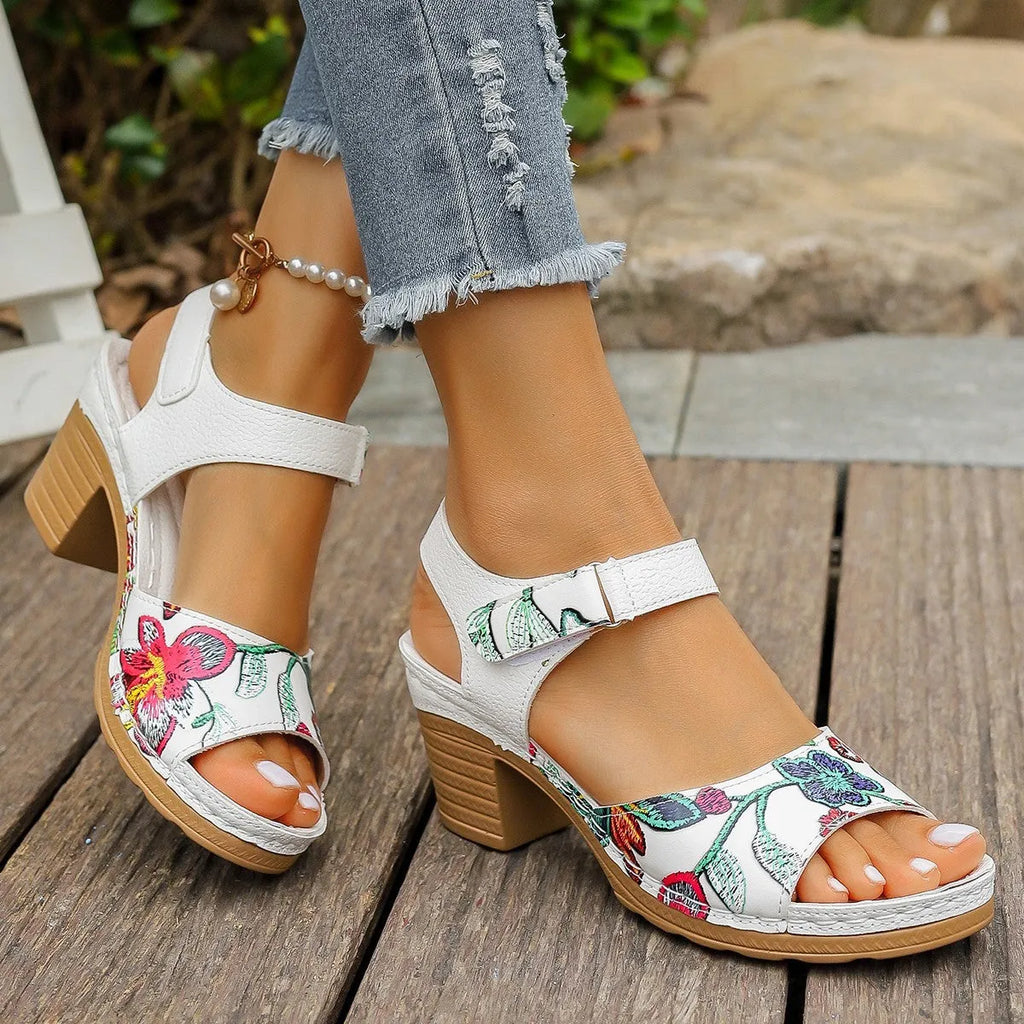 White women's high heel sandals with an adjustable velcro strap buckle fastening.