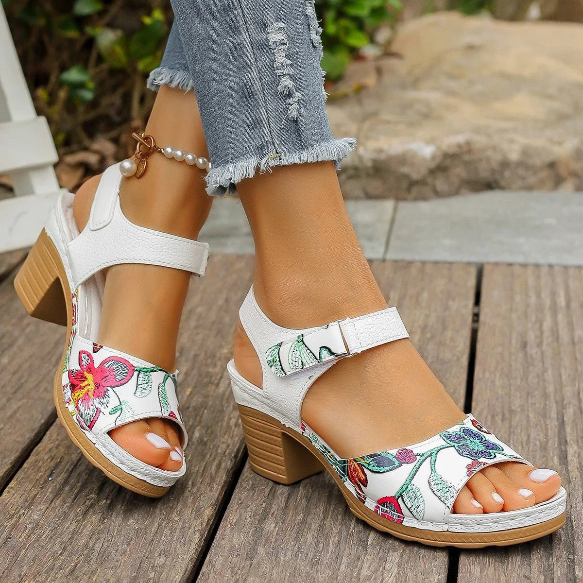 White women's high heel sandals with an adjustable velcro strap buckle fastening.