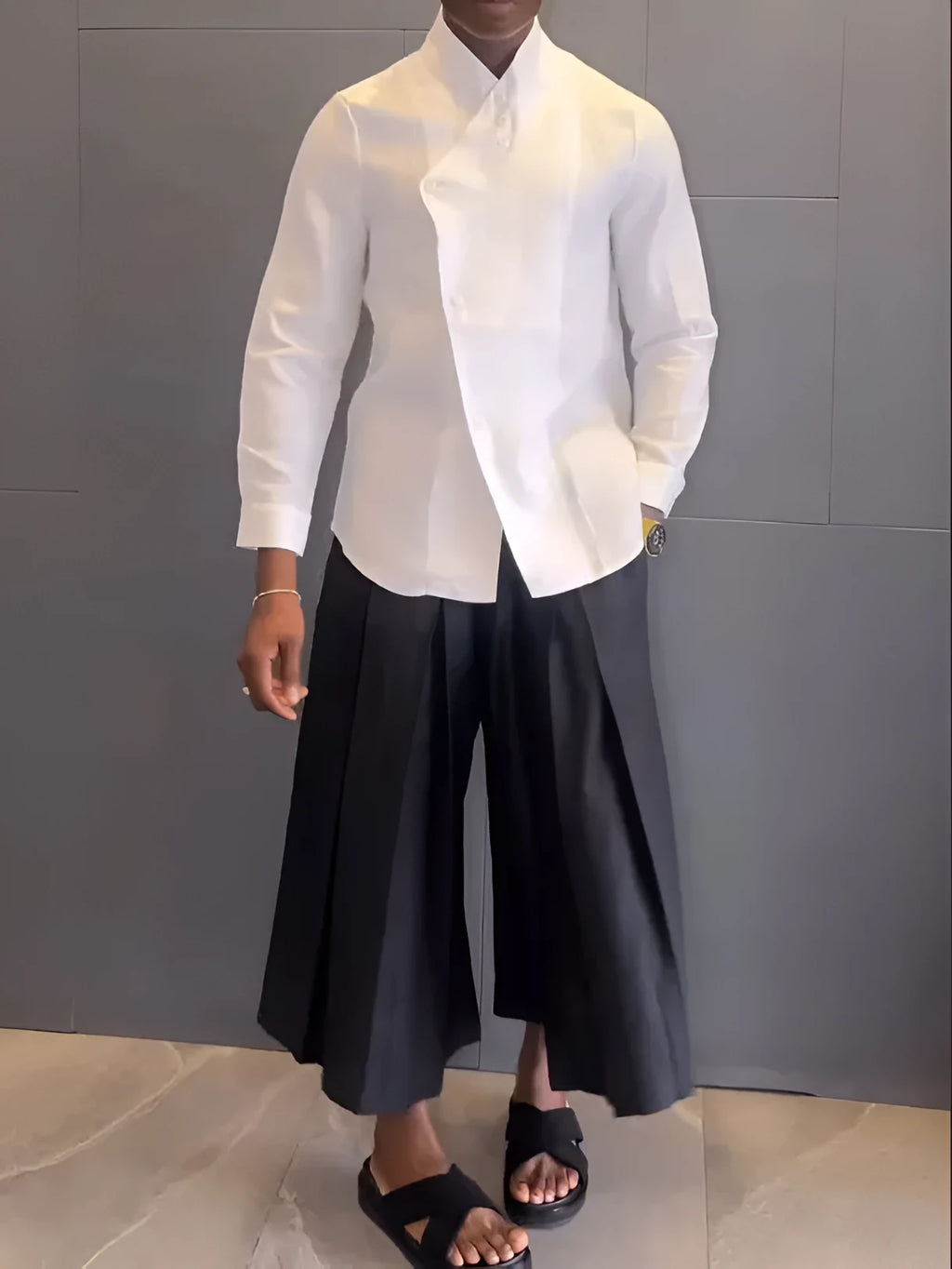 White asymmetric front long sleeve shirt and black pleated trousers co-ordinates set on a hanger