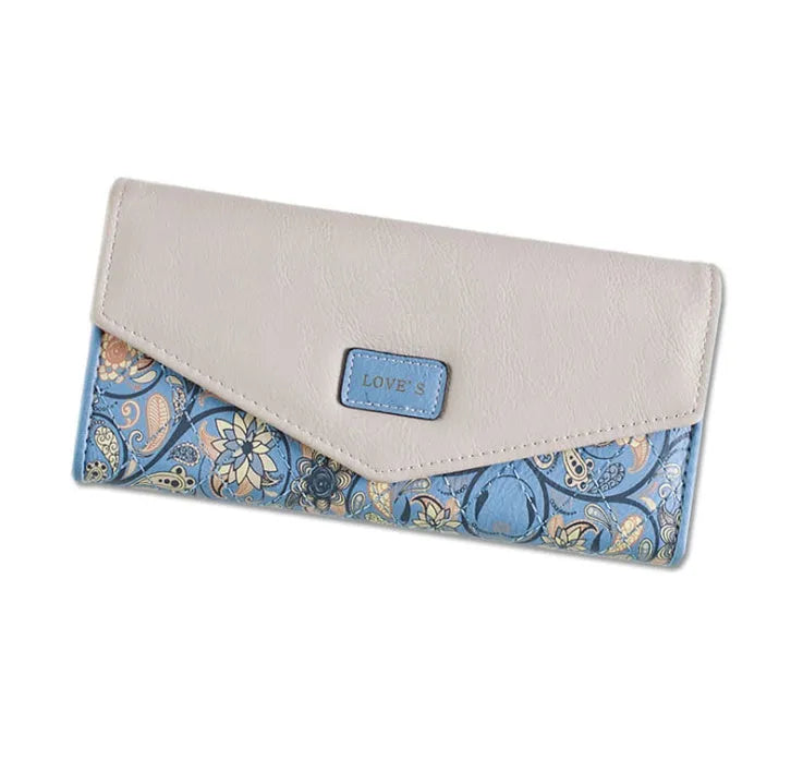Women's black three-fold wallet with buckle closure showing interior compartments