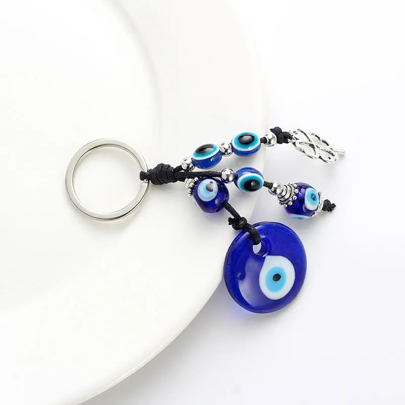 Blue evil eye keychain with metal plant-shaped pendant and unisex keyring design