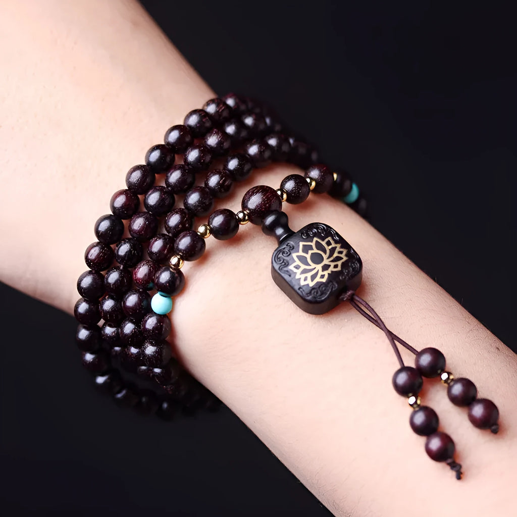 Zambia rosewood Buddha bead bracelet with flat lotus pendant, showing 108 wooden beads.