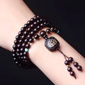 Zambia rosewood Buddha bead bracelet with flat lotus pendant, showing 108 wooden beads.