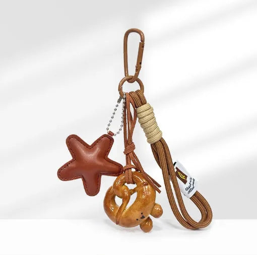 Handmade soda bread handbag pendant charm with cartoon bread designs on brown leather strap