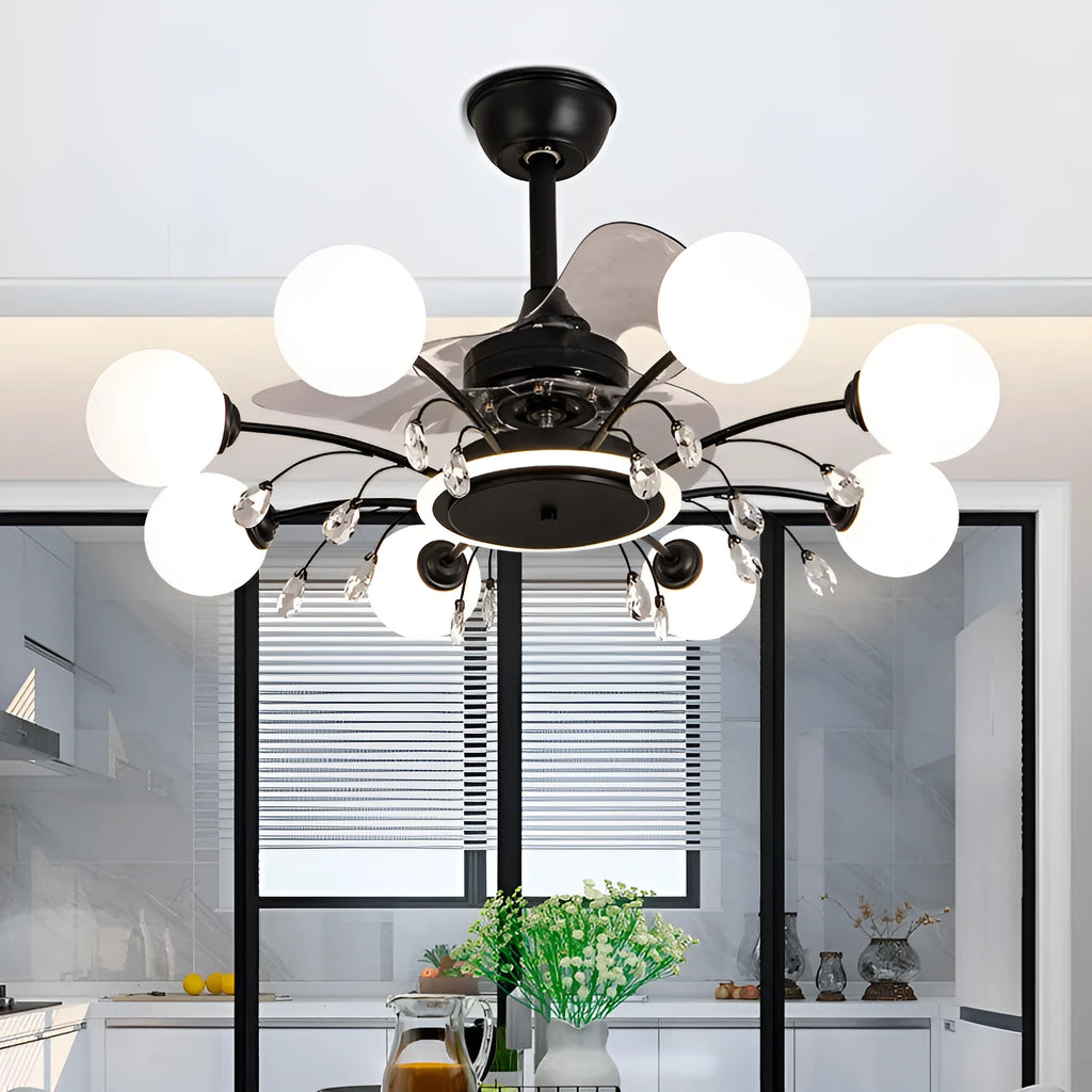 Black and gold ceiling fan light fixture with acrylic shade and metal blades, shown with remote control
