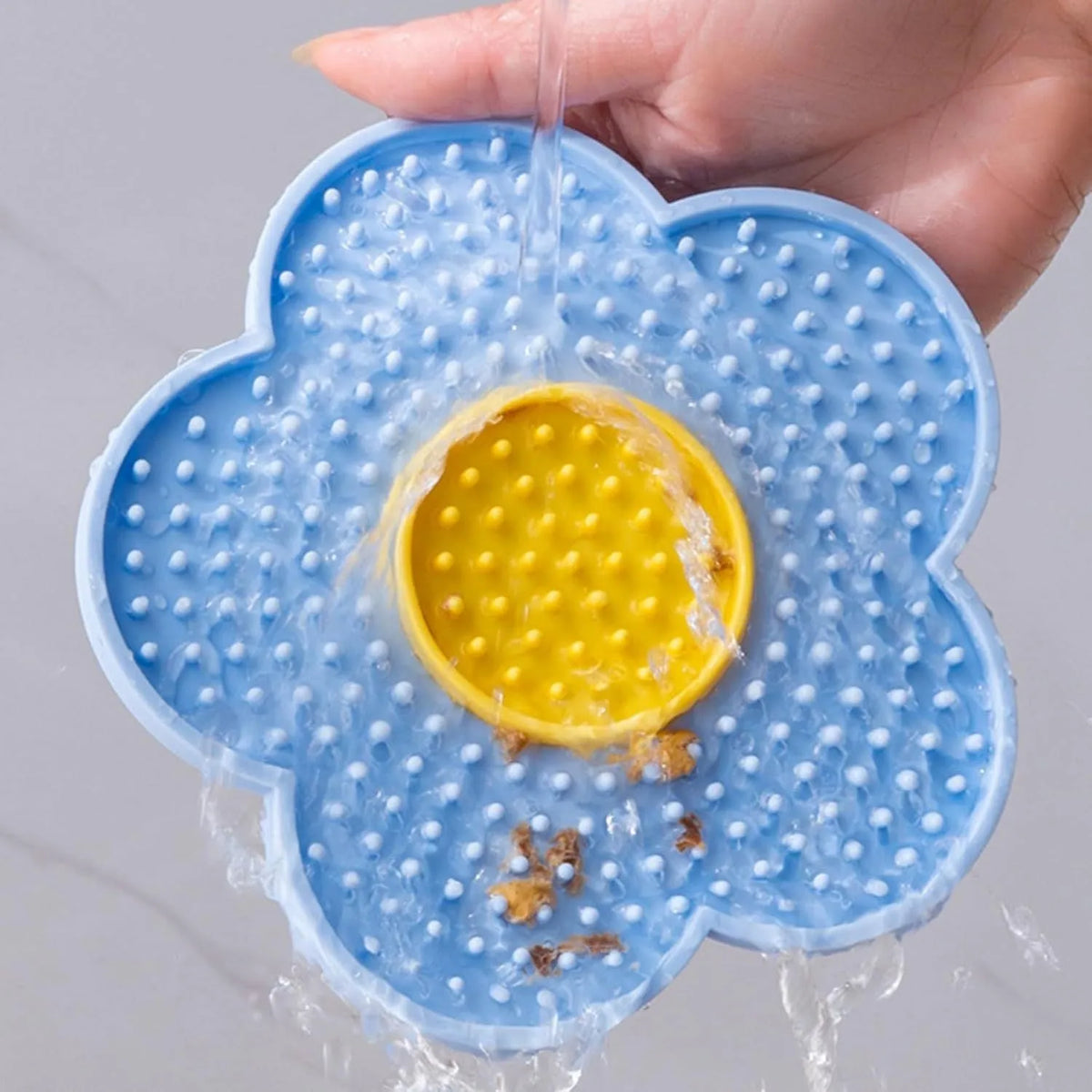 Flower-shaped silicone licking mat for dogs and cats with suction cups on the back.