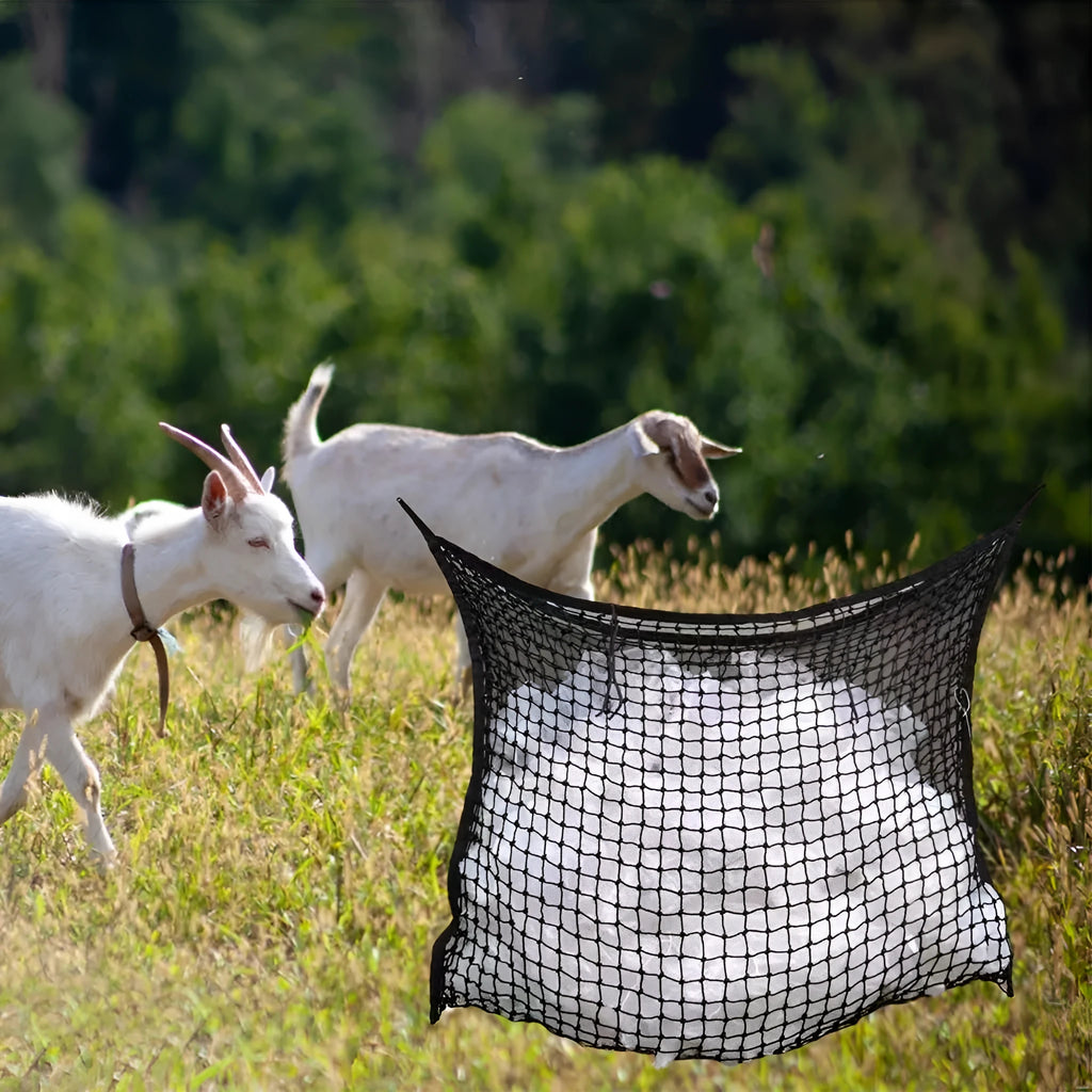 Woven grid horse feeding bag hanging with hay, shown in black colour
