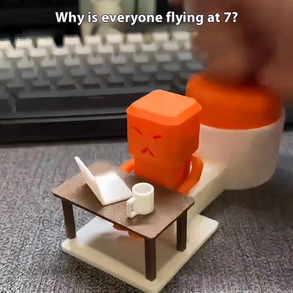 Orange plastic rotating decompression toy on a desk, showing its 16cm length.