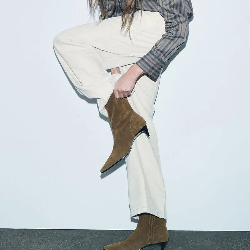 Brown square toe ankle boots with a side zip and a low kitten heel on a waterproof platform.