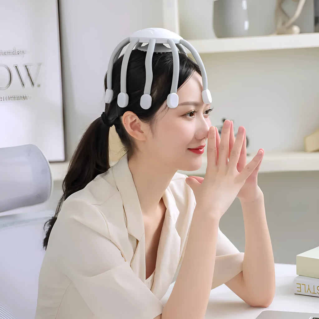 Black and white head massager with multiple claws and USB charging port showing four vibration mode settings