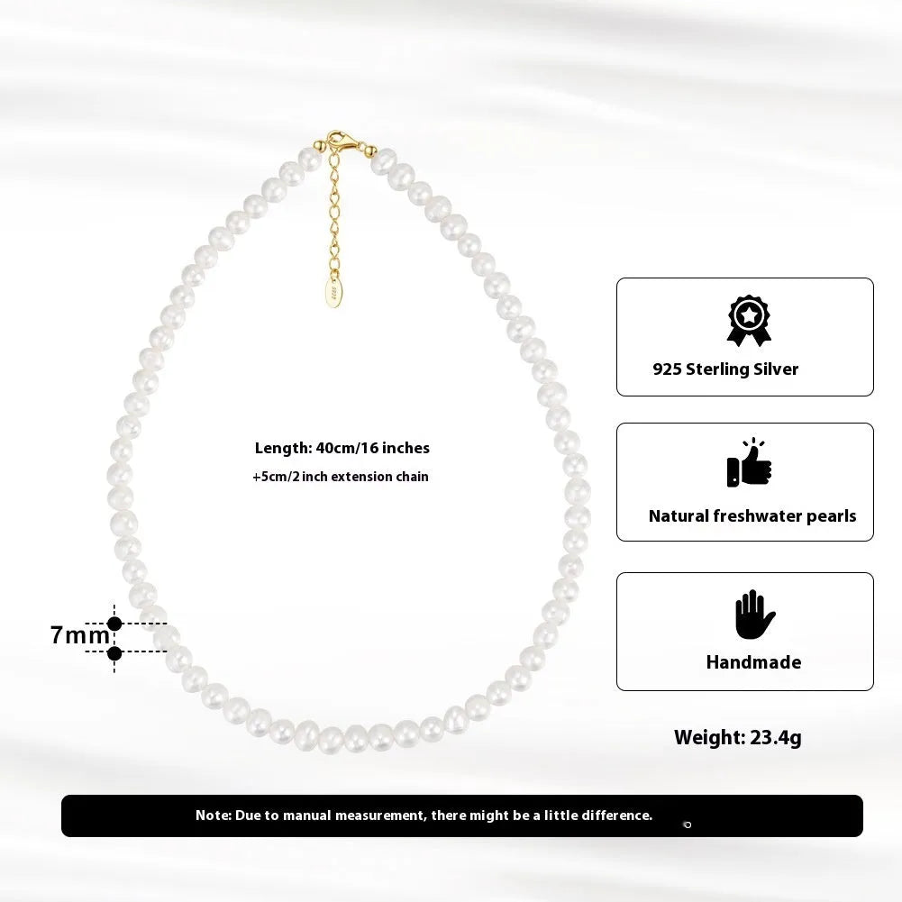 Women's simple sterling silver necklace with round freshwater pearls on an adjustable chain.