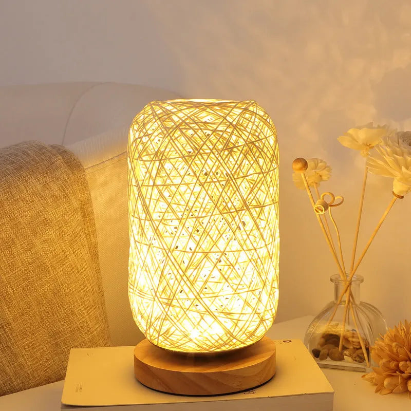 Brown hemp rope desk lamp with spherical shade on circular wood base