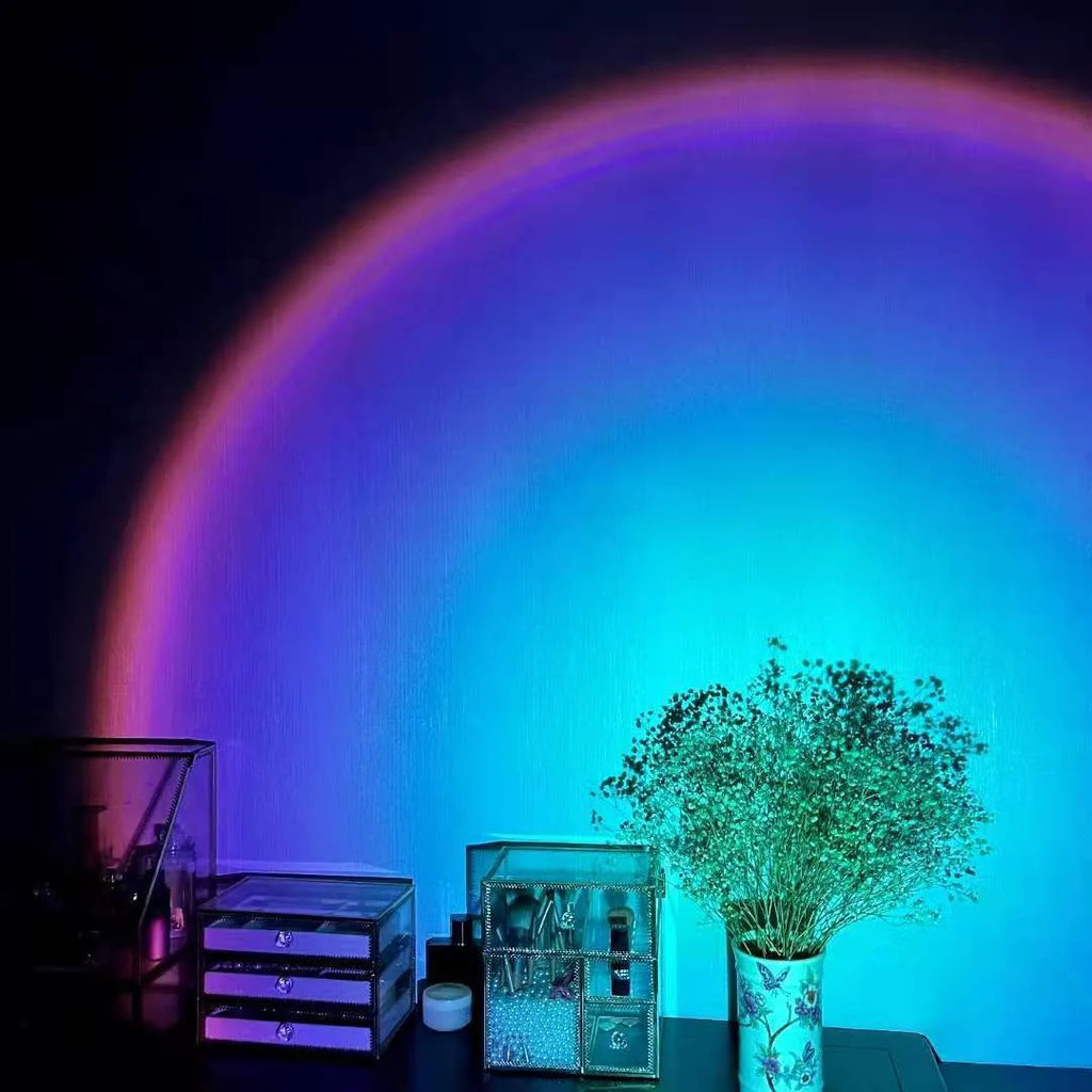 Rechargeable sunset red rainbow projection lamp with USB cable on tabletop