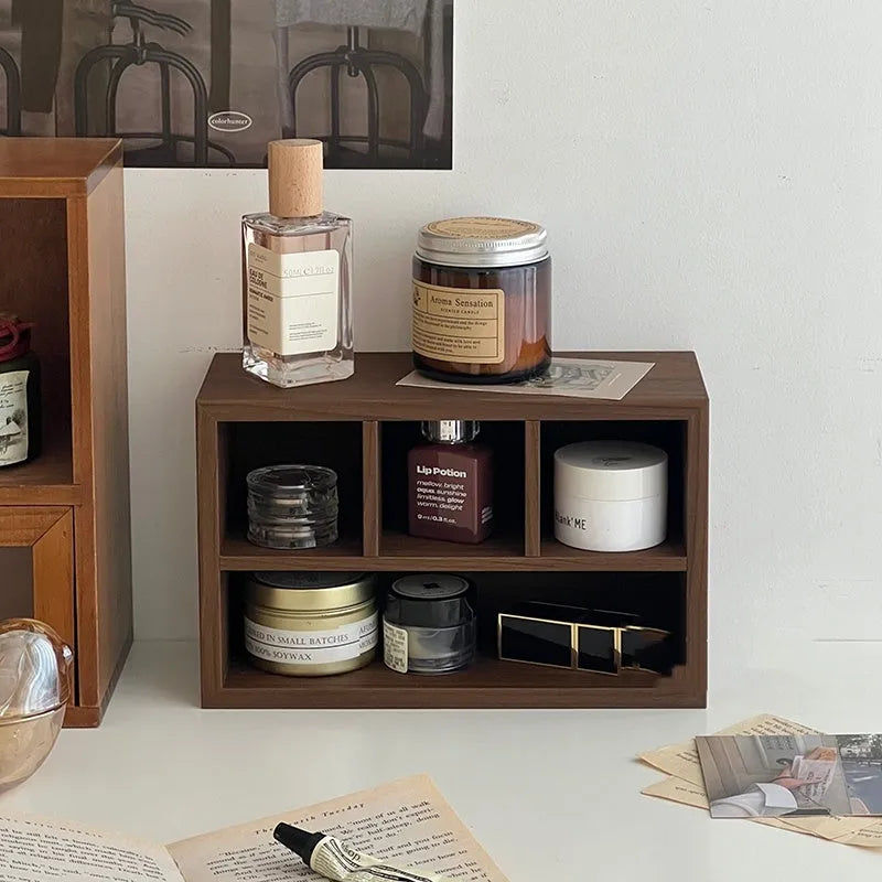 Retro wood desktop grid storage box with four short cells on a desk organising pens and sundries