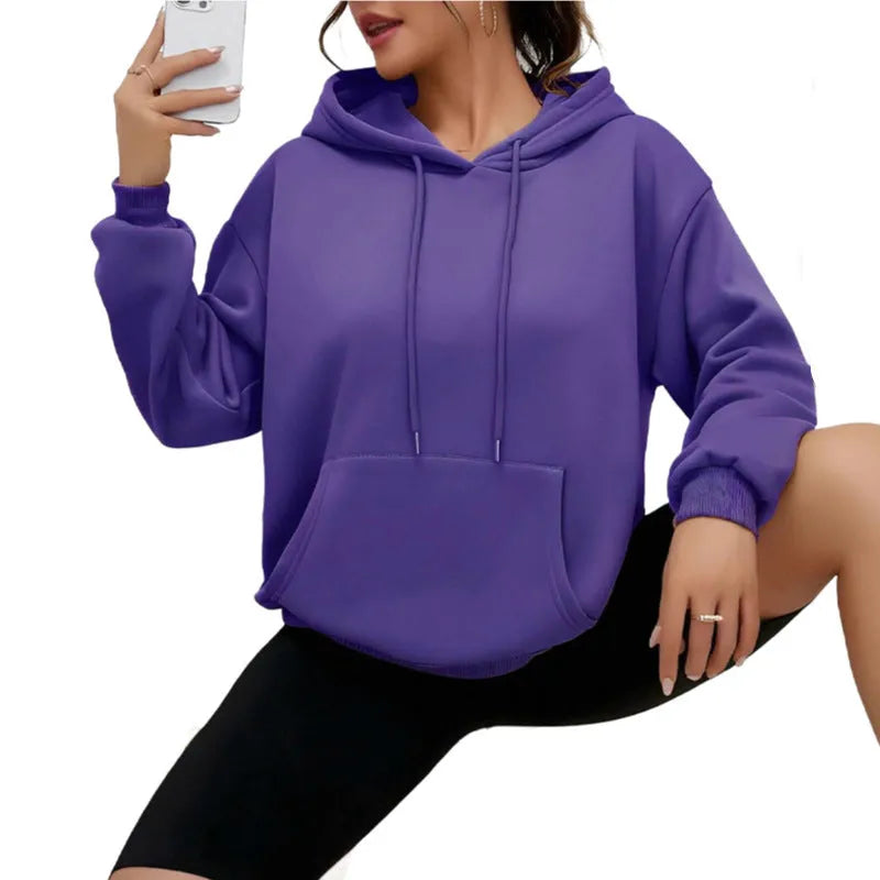 Women's loose grey drawstring hoodie with front pockets on a hanger.