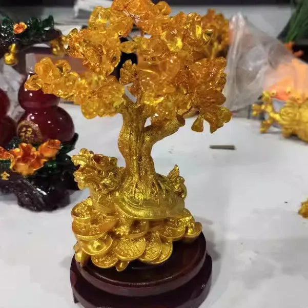 Citrine-coloured resin money tree ornament with a small turtle, measuring 18 by 23 cm.