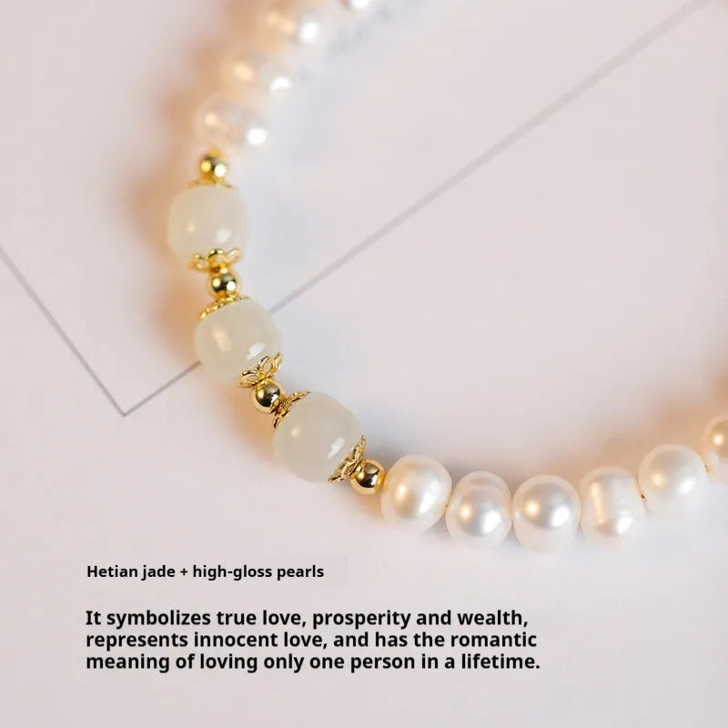 Natural freshwater pearl bracelet with diamond-shaped beads in Hetian jade colour on a wrist.