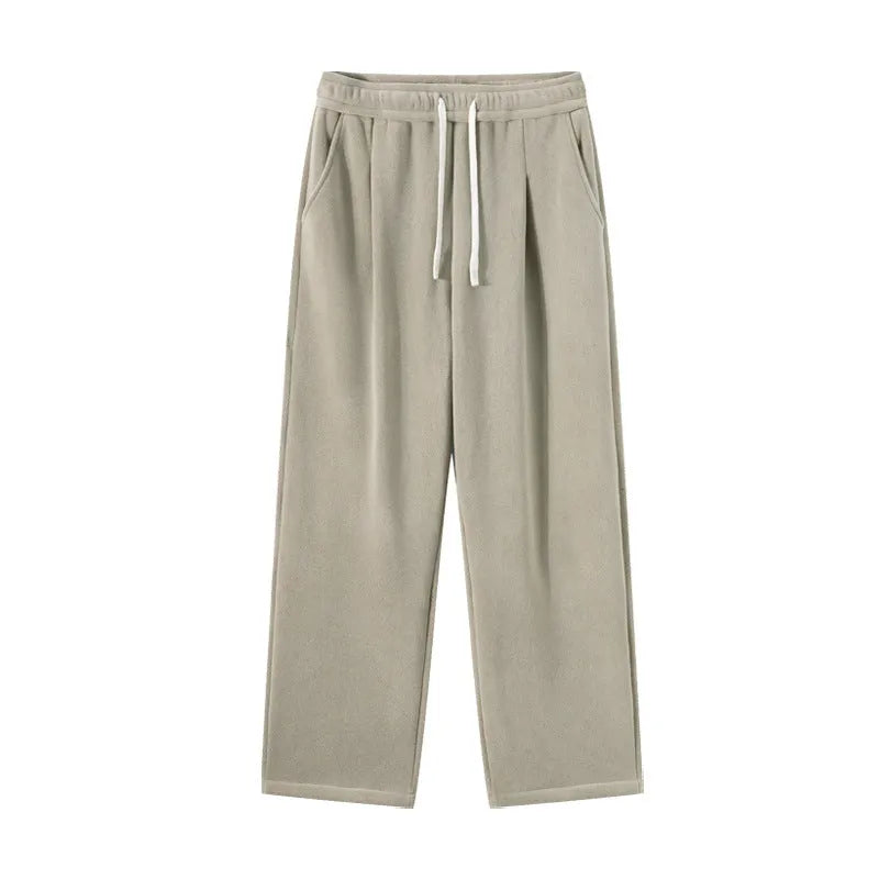 Men's loose fit apricot coloured fleece-lined sports pants with a drawstring waist on a hanger