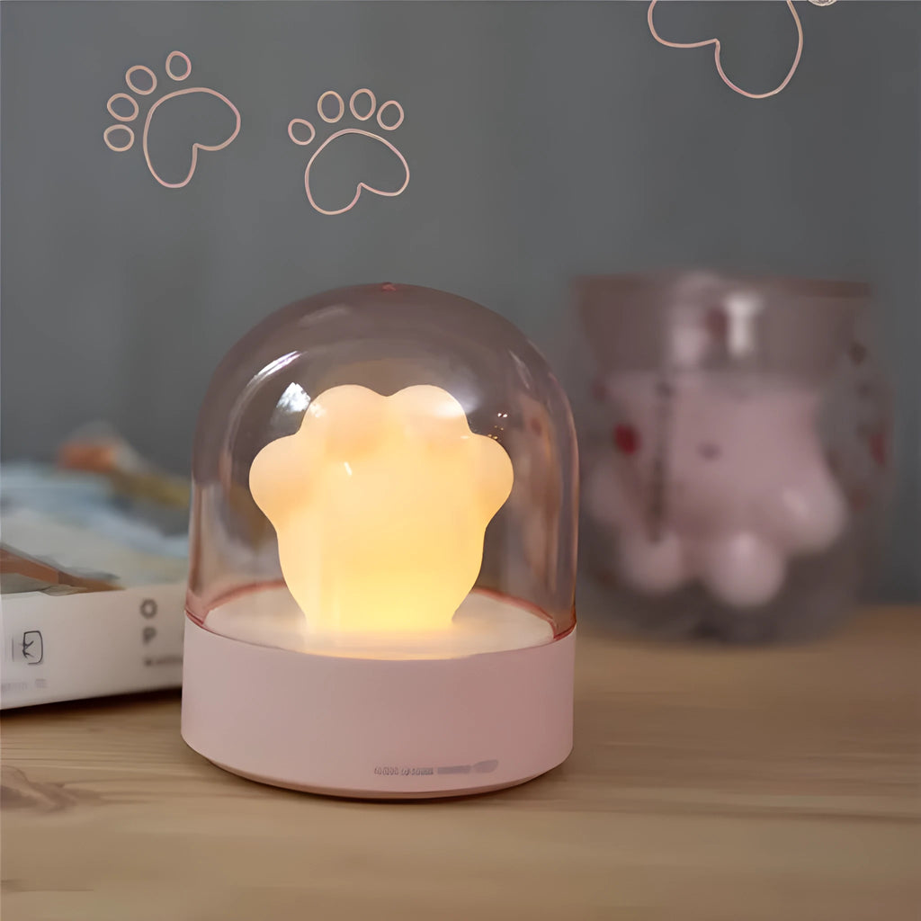 Grey and pink cat paw shaped night light with USB charging cable and musical rotation feature