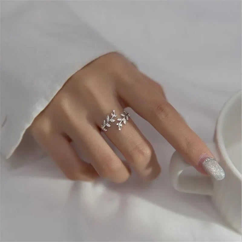 A geometric copper leaf-shaped ring for women, shown in both gold and silver electroplated finishes.
