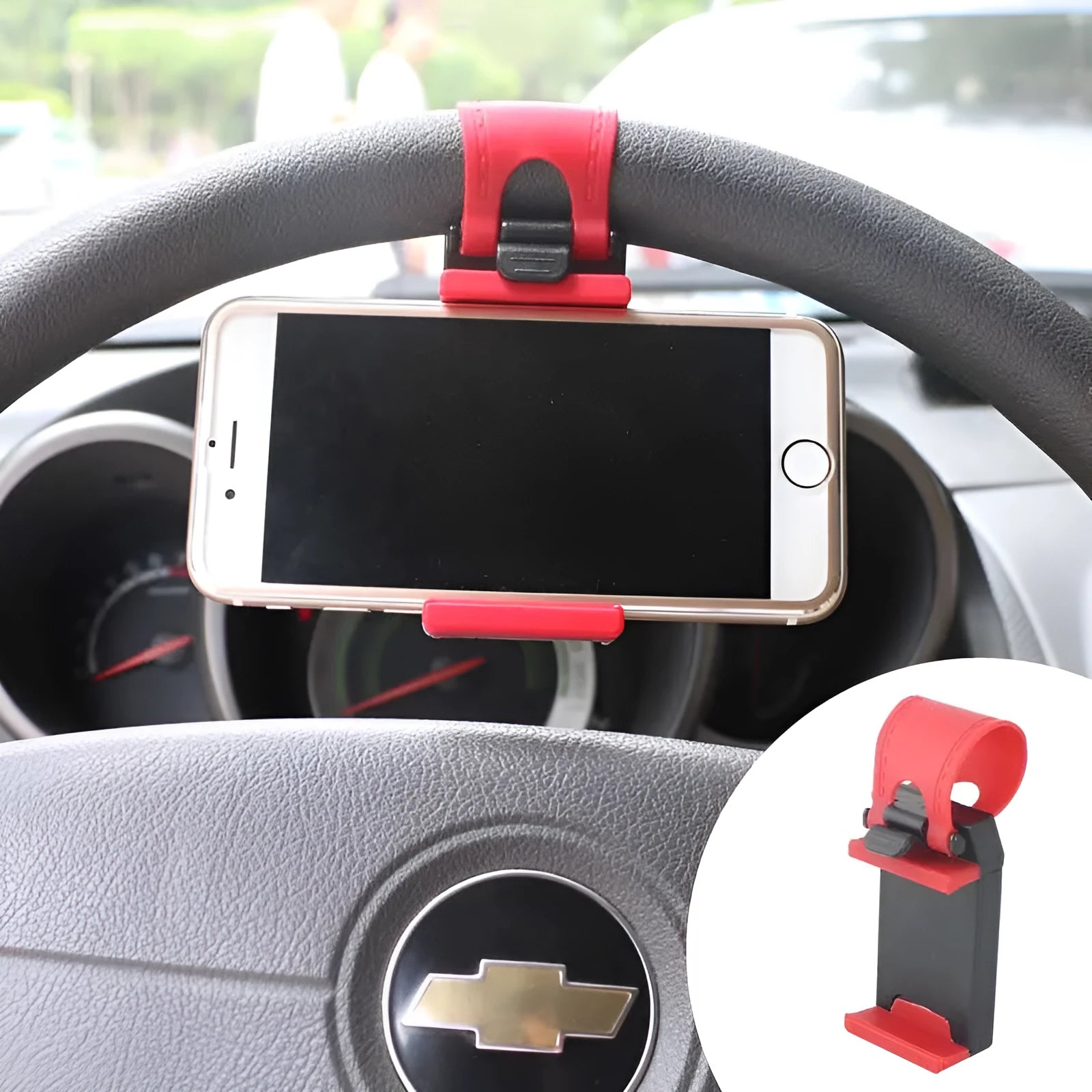 Black steering wheel phone mount holder clipped to a car wheel, holding a large smartphone.