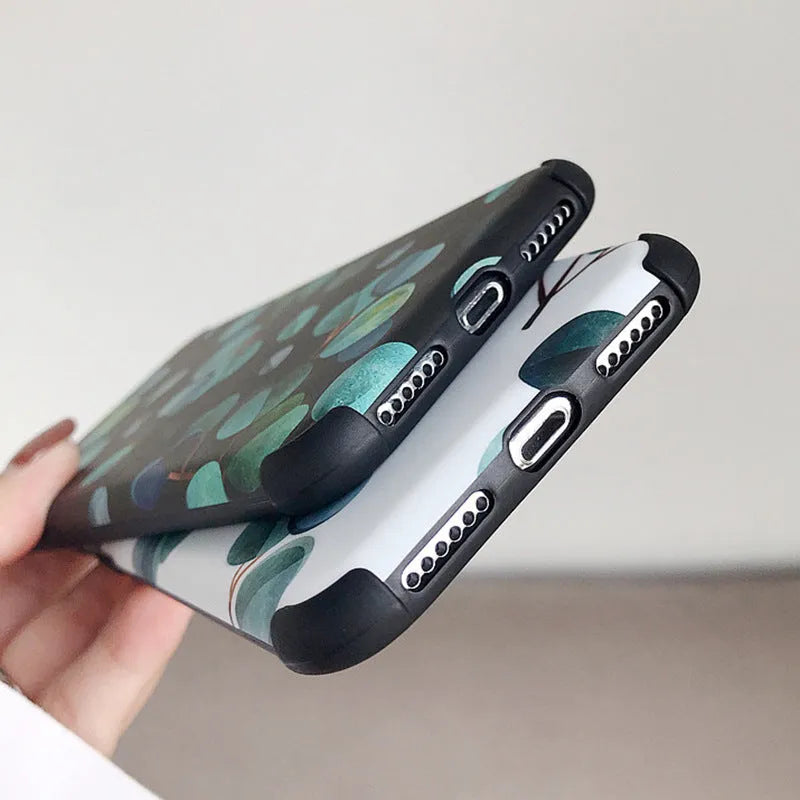 Black silicone iPhone case featuring a printed leaf design, shown fitted to a phone.