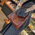 Women's large capacity first layer cowhide leather tote bag in square vertical shape with open pocket and multiple interior compartments.