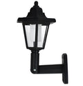 Black hexagonal solar-powered outdoor wall light with visible solar panel.