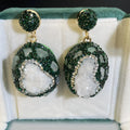 Crystal Bud Inlaid Emerald Earrings in dark green with a copper geometric base and crystal bud detail on a white background