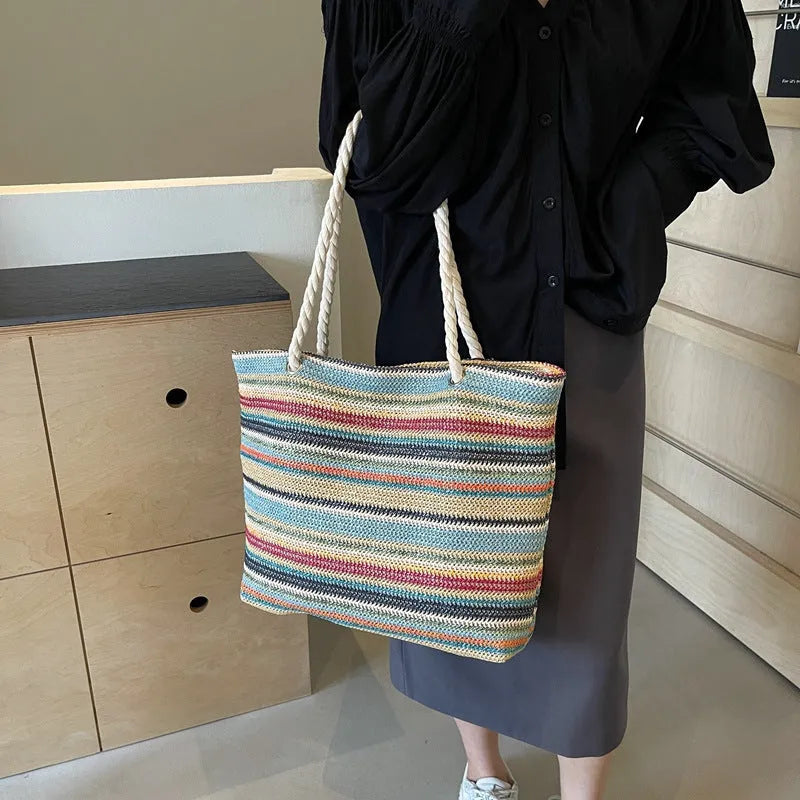 Blue woven nylon shoulder bag with large capacity and straw-style texture showing single-shoulder strap and polyester lining.