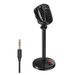 Black USB computer microphone with adjustable stand on desktop for recording and podcasting