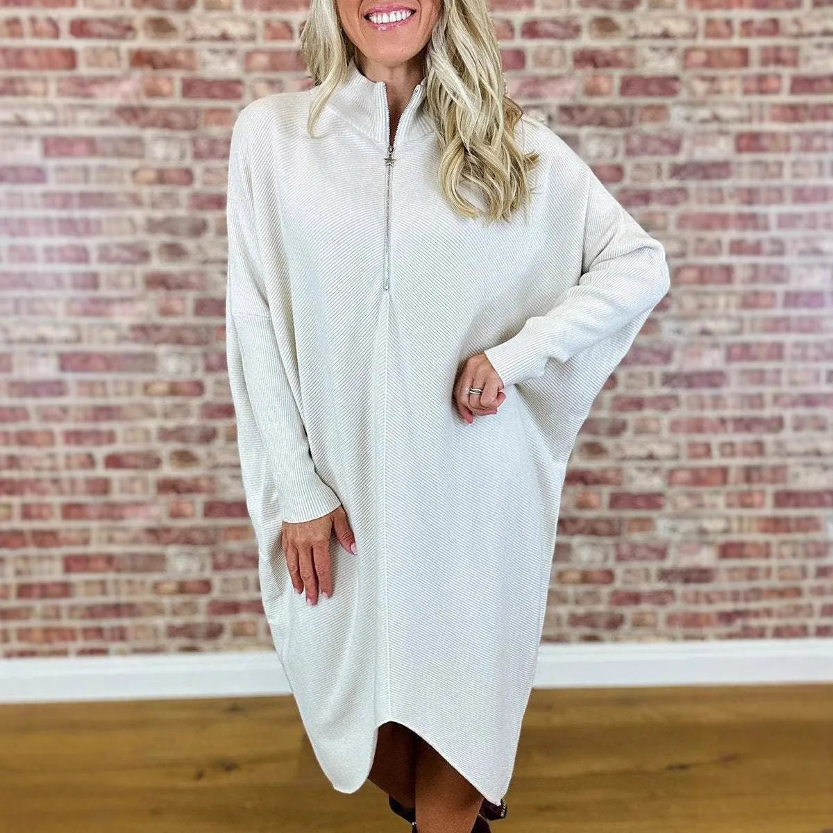Women's solid colour loose fit knitted dress with raglan sleeves and a zip detail.