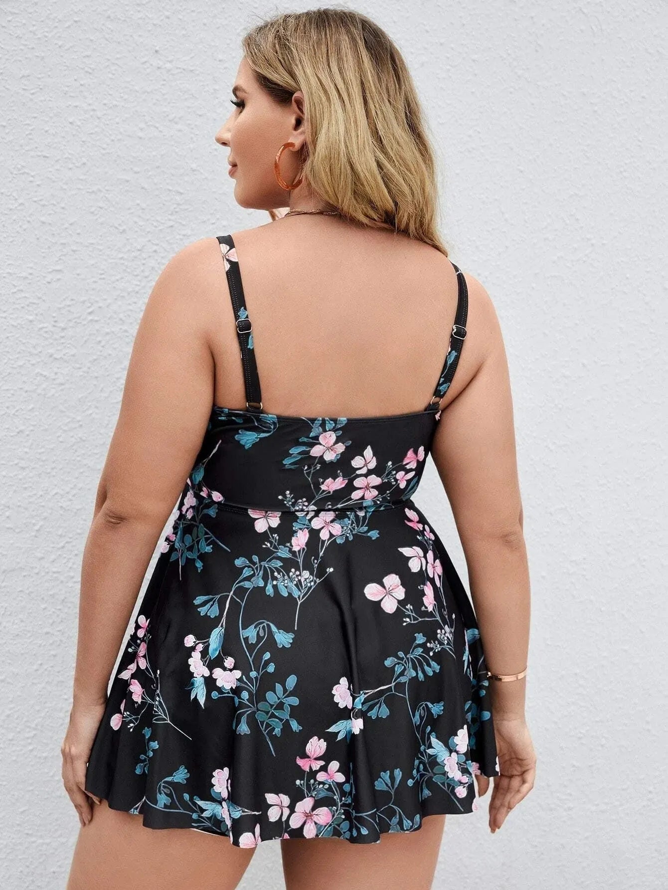 Women's floral print split colour one-piece swimsuit on hanger showing front design details