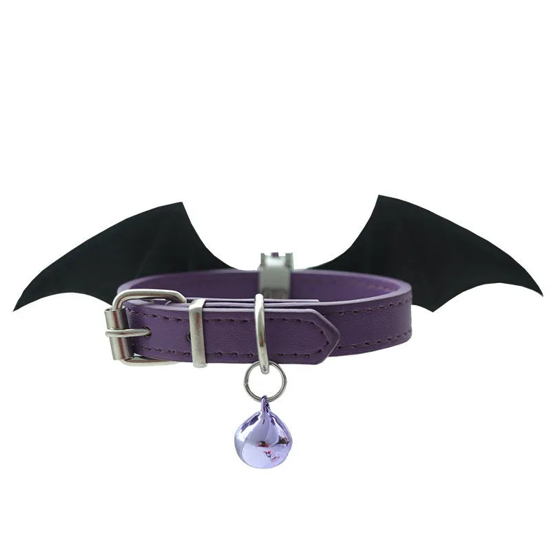 Black patent leather collar with attached metal devil wings and small bell charm.