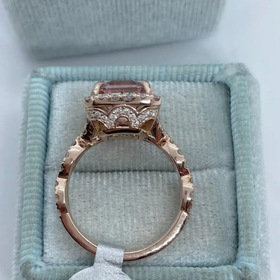 Geometric rose gold alloy ring on a plain background showing its shape and electroplated finish.