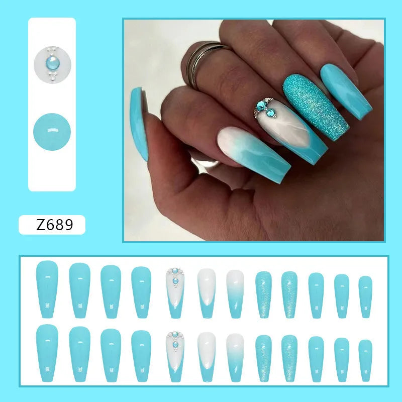 Long oval ballet false nail art patches with a solid smart blue diamond design and glue bottle.
