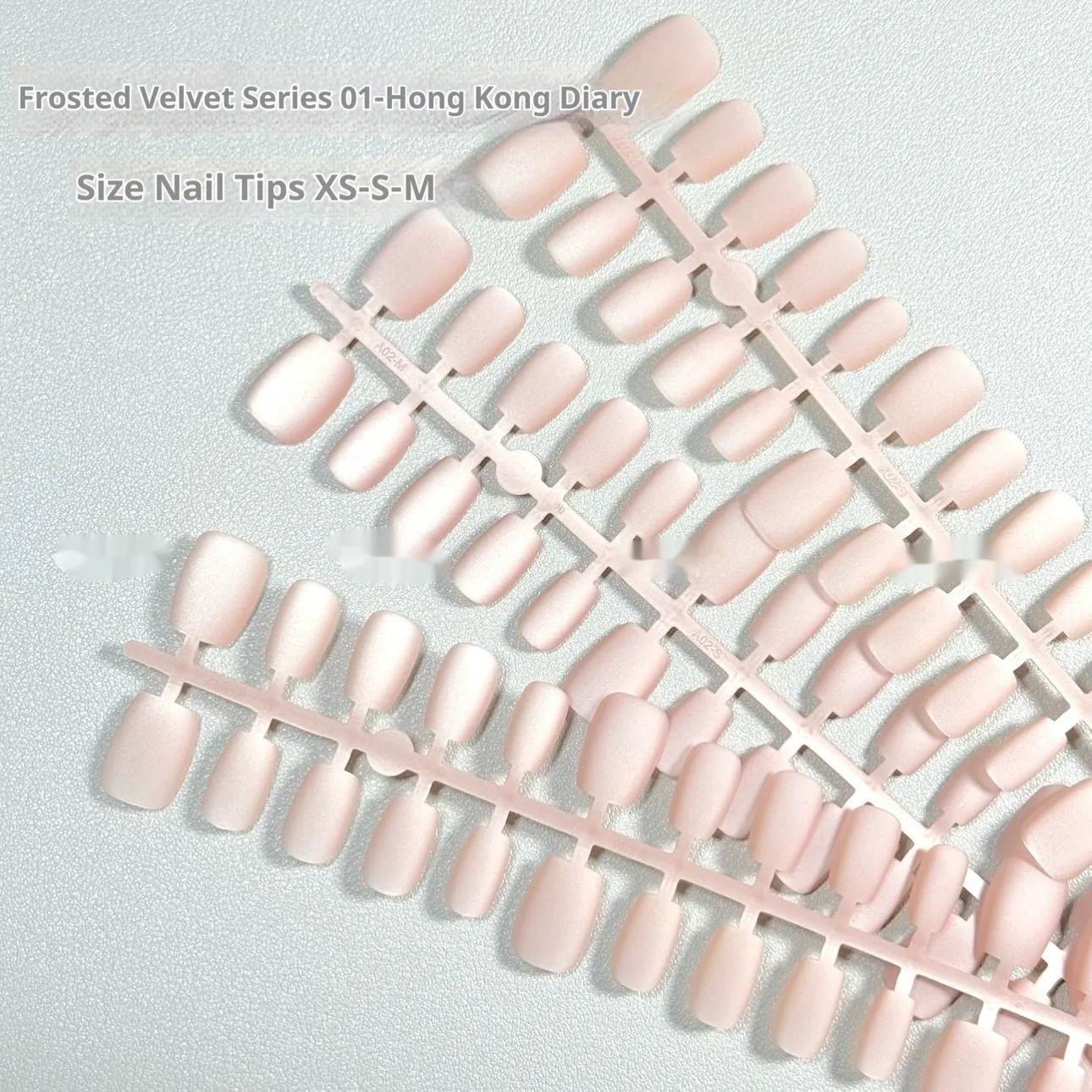 Set of frosted velvet Cat's Eye false nails with Aurora glitter on a clear background, showing short ladder sizes.