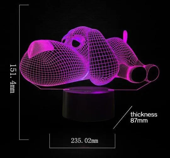 3D illusion dog lamp glowing in multiple colours on a desk with USB cable