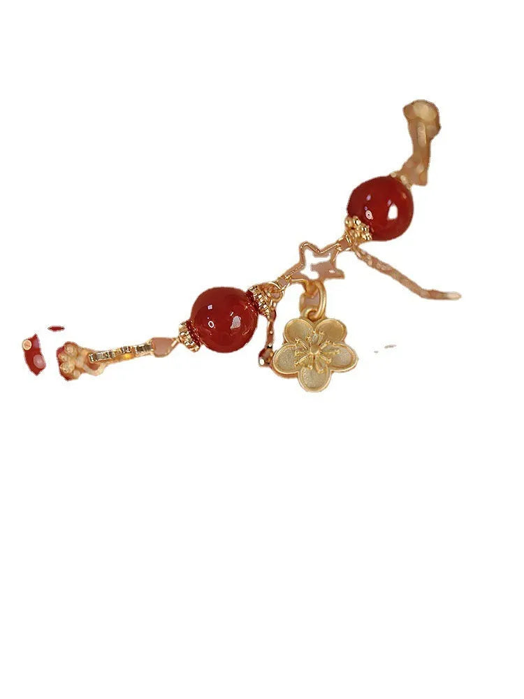 Close-up of natural red agate double layer bracelet with manual floral and peach blossom details for women.