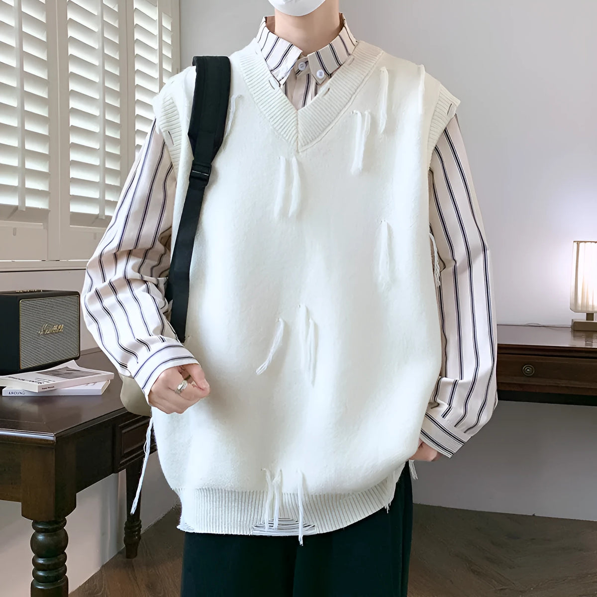 Men's sleeveless modal sweater in loose fit, available in white, grey, black, and green.