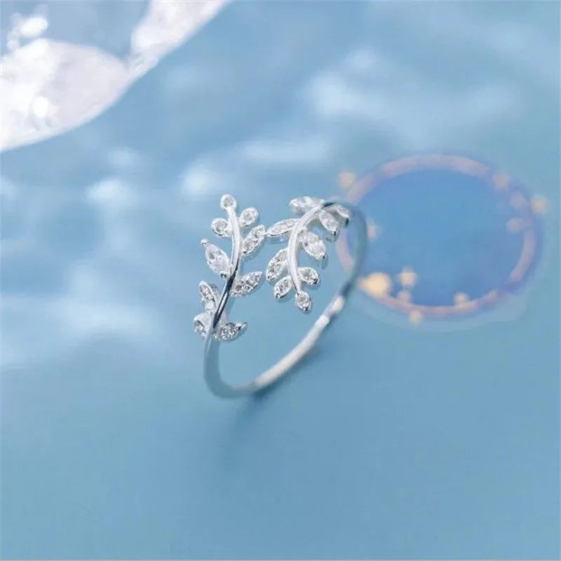 A geometric copper leaf-shaped ring for women, shown in both gold and silver electroplated finishes.